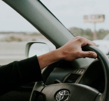 male hand on Toyota steering wheel