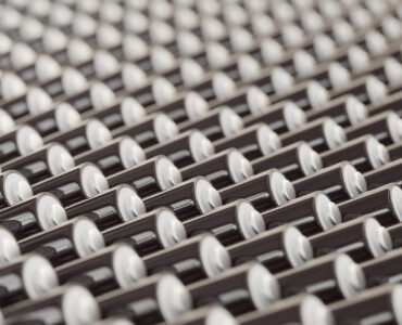 ocean of layered blank black triple-A batteries presented with a shallow depth of field