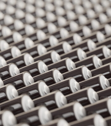 ocean of layered blank black triple-A batteries presented with a shallow depth of field