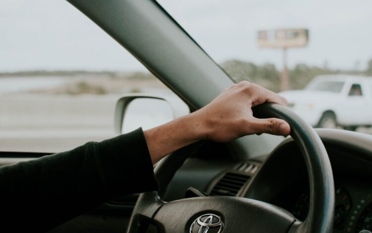 male hand on Toyota steering wheel