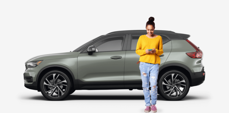 side view of olive SUV car with woman next to the vehicle
