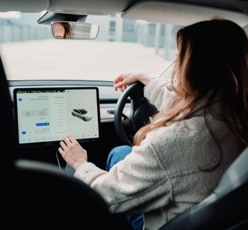 woman inside EV using ipad vehicle app