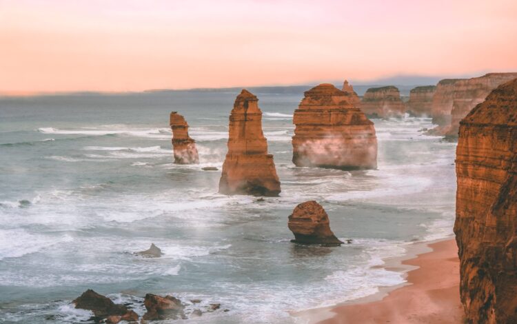 scenic image of the 12 apostles at sunrise with haze around the rocks