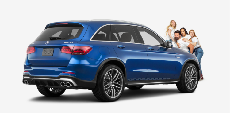 family standing in front of a blue mercedes benz GLC43