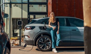 a woman charging her electric SUV