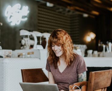 woman inside cafe on a laptop