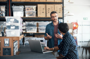man and woman having a discussion in a workshop