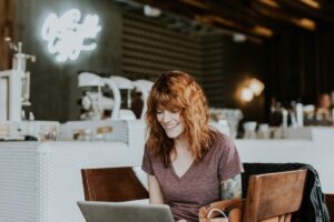 woman inside cafe on a laptop