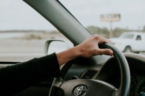 male hand on Toyota steering wheel