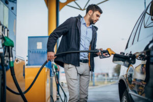 man putting petrol into a car