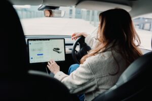 woman inside EV using ipad vehicle app