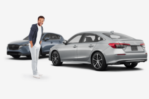 happy man standing next to silver honda