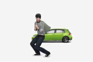 male burglar walking away from car after theft