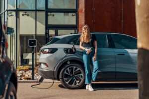 a woman charging her electric SUV