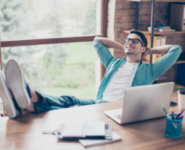 happy calm smiling man having a rest after solving all the tasks at work