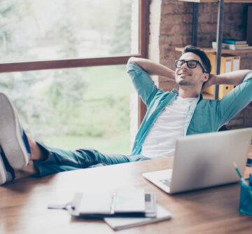 happy calm smiling man having a rest after solving all the tasks at work