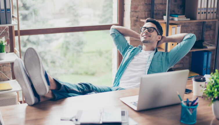 happy calm smiling man having a rest after solving all the tasks at work