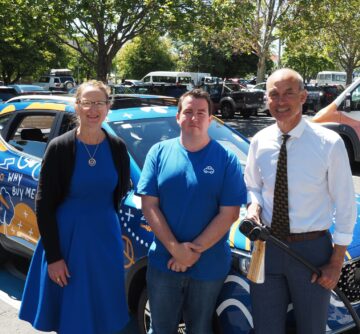 carbar employees standing in front of vehicle for aurora energy launch