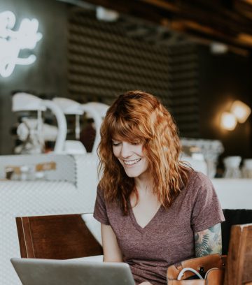 woman inside cafe on a laptop