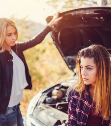 Young girls experiencing problems with broken down car