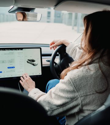 woman inside EV using ipad vehicle app