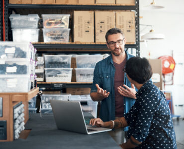 man and woman having a discussion in a workshop