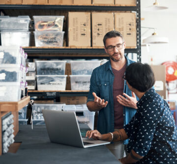 man and woman having a discussion in a workshop