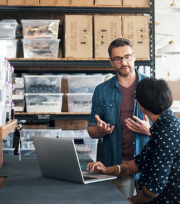 man and woman having a discussion in a workshop