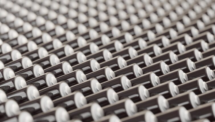 ocean of layered blank black triple-A batteries presented with a shallow depth of field