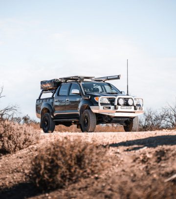 black toyota hilux ute with roof racks