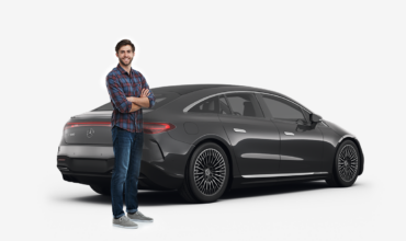 man standing in front of a black mercedes benz