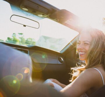 young happy woman in a car subscription vehicle