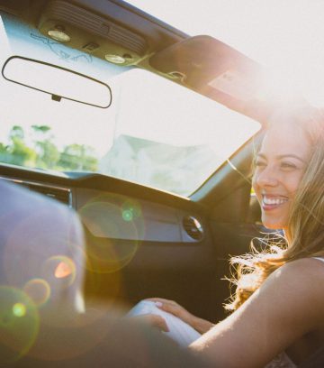 young happy woman in a car subscription vehicle