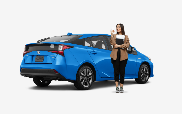 woman standing in front of blue hybrid toyota prius