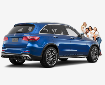 family standing in front of a blue mercedes benz GLC43