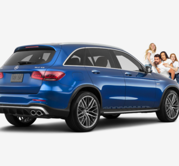 family standing in front of a blue mercedes benz GLC43