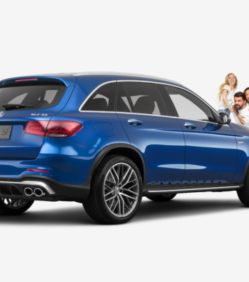 family standing in front of a blue mercedes benz GLC43