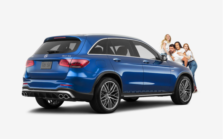 family standing in front of a blue mercedes benz GLC43