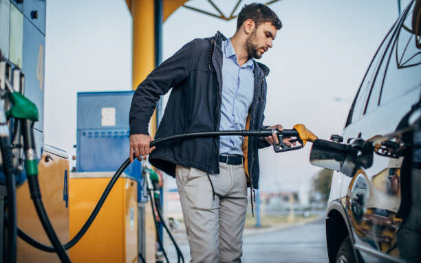 man putting petrol into a car