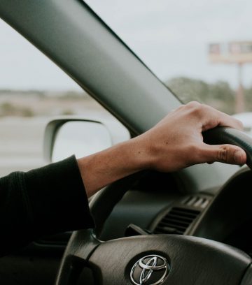 male hand on Toyota steering wheel