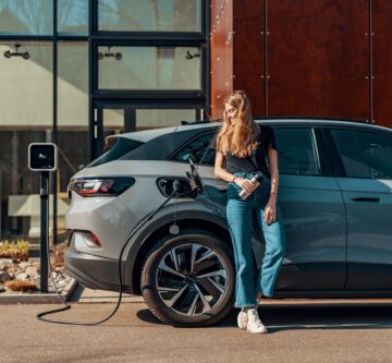 a woman charging her electric SUV