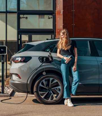 a woman charging her electric SUV