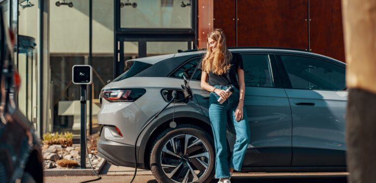 a woman charging her electric SUV